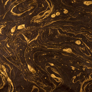 Gold marble on brown paper